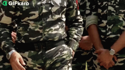 Soldiers In Camouflage Holding Hands GIF