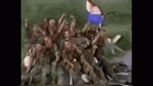 Soldiers In Field With Hands Up GIF