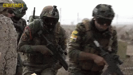 Soldiers in Helmets and Goggles Holding Guns in Field