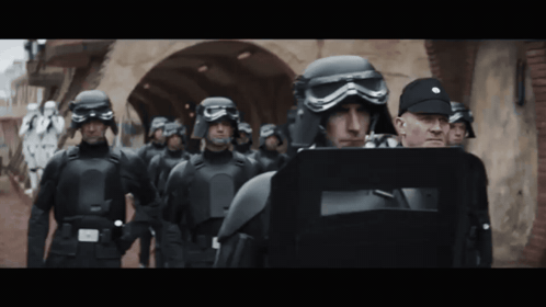Soldiers in Helmets and Goggles Walking Down Street