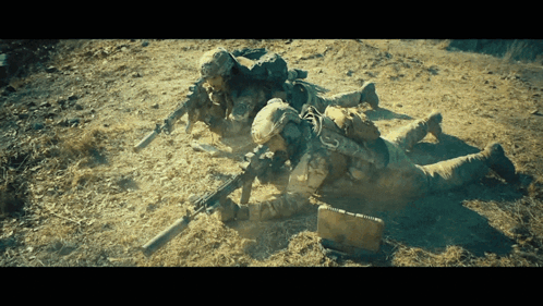 Soldiers Laying In Dirt With Guns GIF