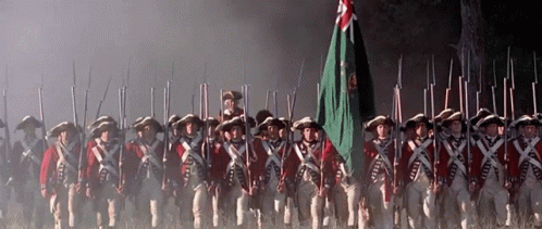 Soldiers Marching in a Line with Army Flag
