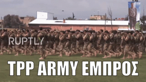 Soldiers Marching in Field With Ruptly Text