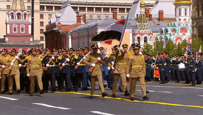Soldiers Marching in Front of Building Saying 100