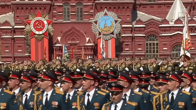 Soldiers Marching in Front of Building with CCCP Medal