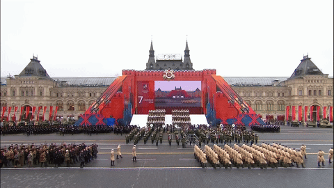 Soldiers Marching Past Screen Saying 7 GIF