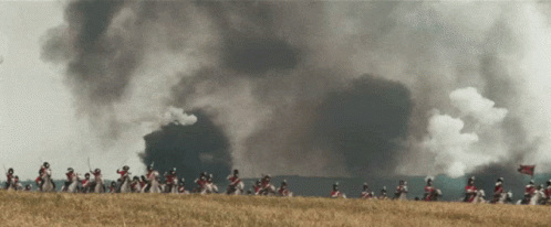 Soldiers Riding Horses With Smoke From Building