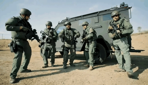 Soldiers Standing In Front Of Military Vehicle GIF