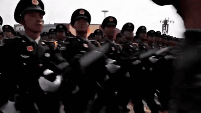 Soldiers Standing in Front of Red Flag