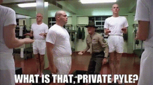 Soldiers Standing in Locker Room With Soldier Kneeling