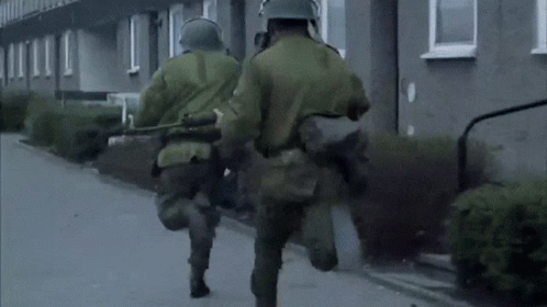 Soldiers Wearing Gas Masks and Helmets Walking