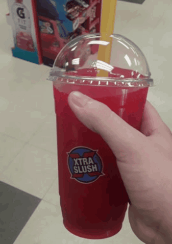Someone Is Holding A Cup Of Xtra Slush GIF