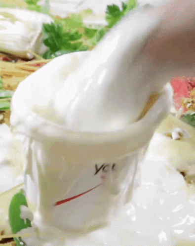 Someone Pouring Mayonnaise Into You Container