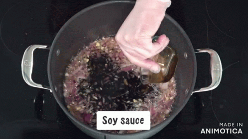 Soy Sauce Is Being Added To A Pot Of Food GIF