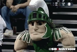 Spartan Mascot Sitting on Bleacher in Front of CBS Logo