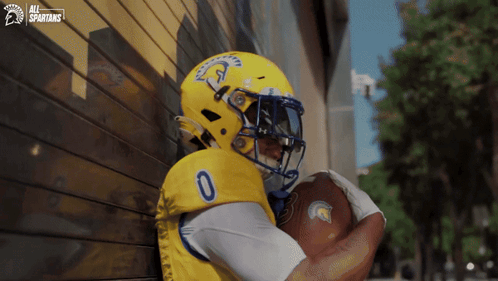 Spartans Football Player Holding Football