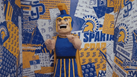Spartans Mascot in Front of Spartans Logos Wall
