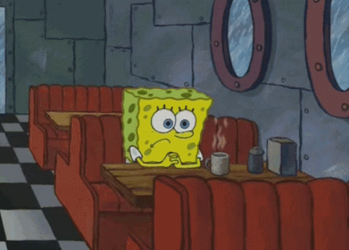 Spongebob Sits At A Table In A Diner With A Cup Of Coffee GIF