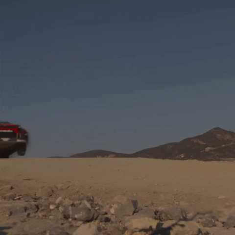 Sports Car Flying Over Dirt GIF