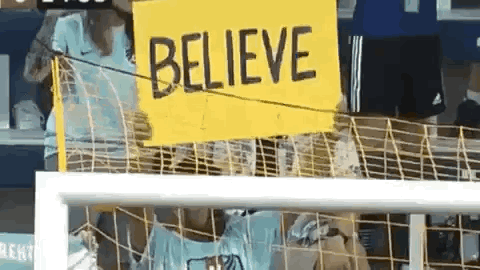 Sports Fan Raising Ted Lasso Believe Sign GIF