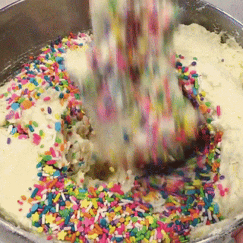 Sprinkles Poured Into Batter in Metal Bowl