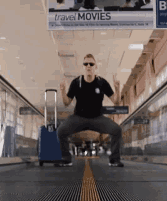 Squatting Travel Guy GIF