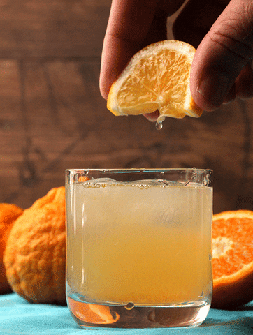 Squeezing Orange On Margarita GIF