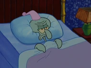 Squidward From Spongebob Is Laying In Bed Wearing A Pink Nightcap GIF