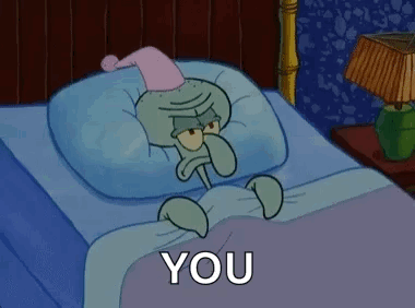Squidward From Spongebob Squarepants Is Laying In A Bed With A Pillow And A Nightcap On . GIF