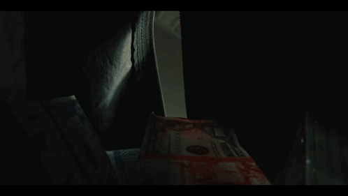 Stack Of 100 Dollar Bills With Bloody Face GIF