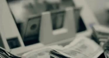 Stack of Money Next to Machine