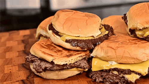 Stacked Hamburgers On Wooden Board GIF