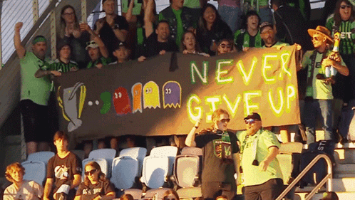 Stadium Crowd Holding Never Give Up Banner GIF