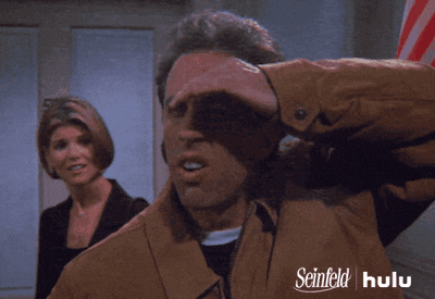 Stalking Jerry Seinfeld Shielding Eyes GIF