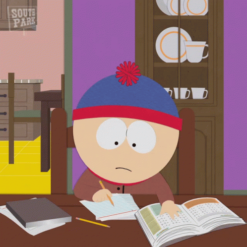 Stan Marsh From South Park Sits At A Desk With A Book GIF
