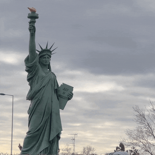 Statue of Liberty Holding Book Saying Liberty or Death