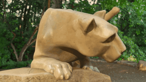 Statue Of Lioness Laying On Rock GIF
