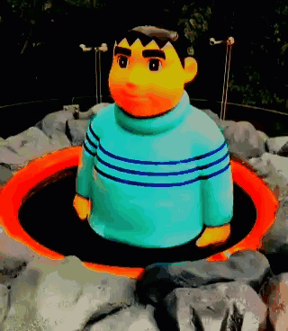 Statue of Man in Blue Sweater in Hole