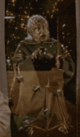 Statue Of Man In Front Of Mirror With Lights GIF