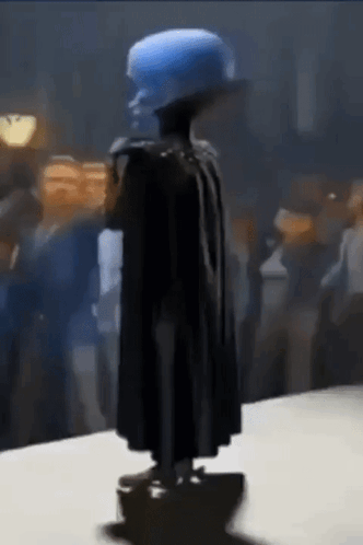 Statue of Man With Blue Hat and Cape