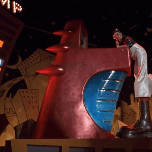 Statue Of Woman On Red Object With Blue Circle GIF