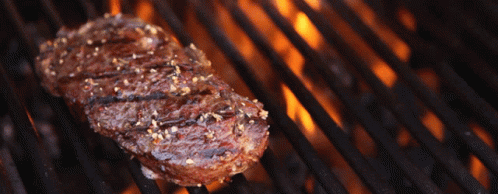 Steak Cooking on Grill with Flames