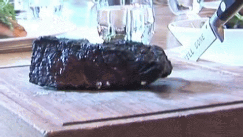 Steak Sliced on Cutting Board Knife Says Feel Done