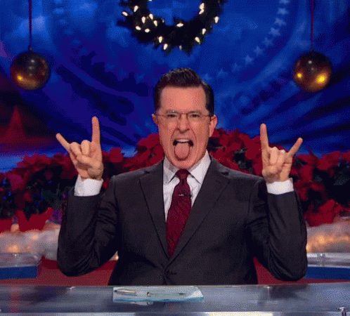 Stephen Colbert Making Hook Em Sign With Tongue Out GIF