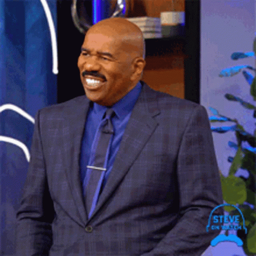 Steve Harvey Smiling In Suit And Tie GIF