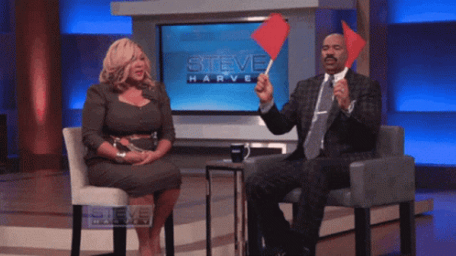 Steve Harvey Waves Two Red Flag GIF