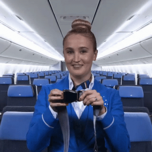 Stewardess in Blue Holding Seat Belt