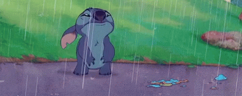 Stitch From Disney 'S Lilo And Stitch Is Standing In The Rain With His Mouth Wide Open . GIF
