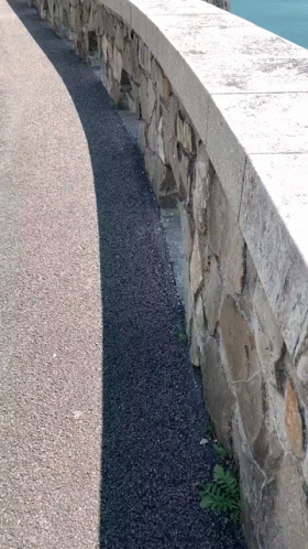 Stone Wall Shadow on Road