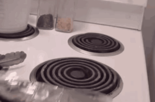 Stove Top With Three Burners and Tongs